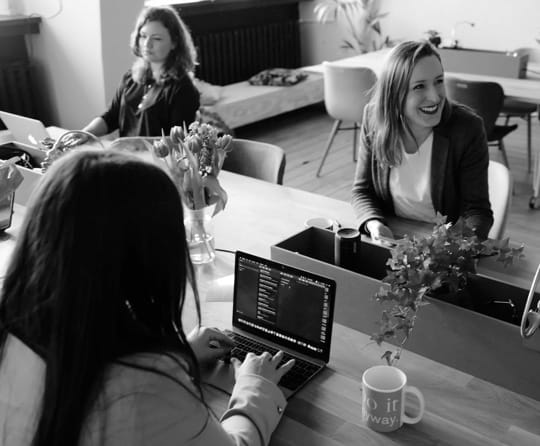 picture of three people working in an office